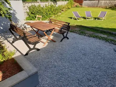 a wooden picnic table and chairs in a yard at Huge BBQ Garden 2, Spacious Flat, AC, Free Parking 2 in Ljubljana