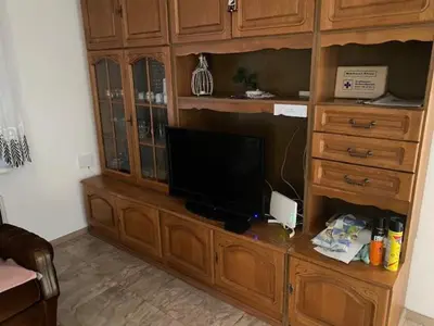 a large wooden entertainment center with a television on it at Živahna hiša in Sveti Jurij ob Ščavnici