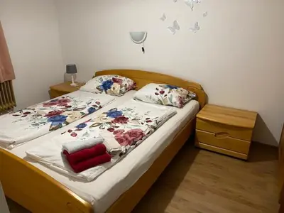 a bedroom with a bed with flowers on it at Živahna hiša in Sveti Jurij ob Ščavnici