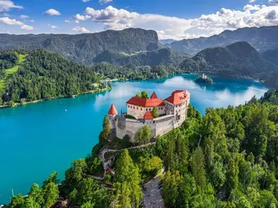 an island in the middle of a lake with a castle at Apartma Ajda in Železniki