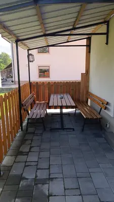 a picnic table and benches on a patio at Studio Mici in Bled