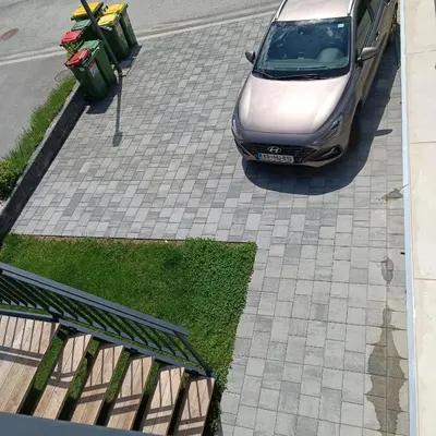 a car parked in front of a parking lot at Studio Mici in Bled