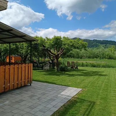 a garden with a pavilion and chairs and a tree at Studio Mici in Bled