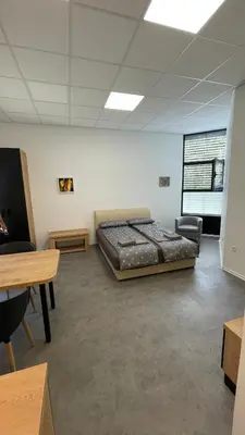 a bedroom with a bed in the middle of a room at Simba Apartment B in Smarjeske Toplice