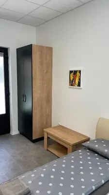a room with a bed and a wooden cabinet at Simba Apartment B in Smarjeske Toplice