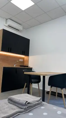 a kitchen with a table and two chairs and a sink at Simba Apartment B in Smarjeske Toplice