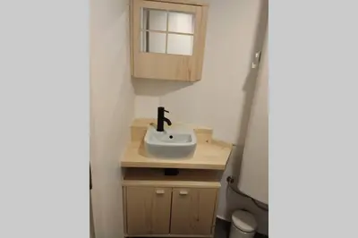 a small bathroom with a sink and a mirror at Bovec Loft apartment in Bovec
