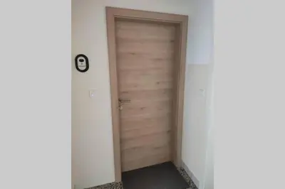 an empty hallway with a wooden door in a room at Bovec Loft apartment in Bovec