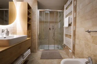 a bathroom with a shower and a sink at Vila Slavc, cosy apartment near the lake in Bled