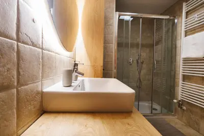 a bathroom with a sink and a shower at Vila Slavc, cosy apartment near the lake in Bled