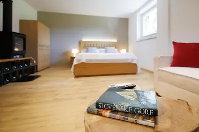 a room with a bed and a book on a table at Vila Slavc, cosy apartment near the lake in Bled