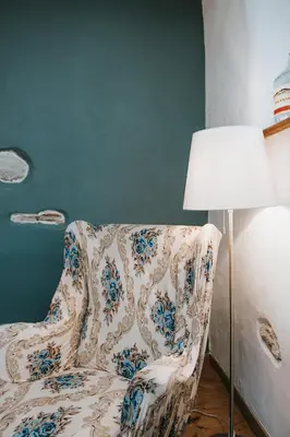 a living room with a chair and a lamp at Hisa Gradnikova in Tolmin