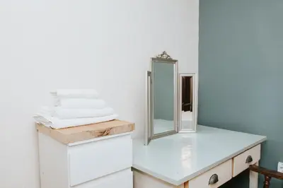 a bathroom with a mirror and a white dresser at Hisa Gradnikova in Tolmin