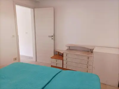 a bedroom with a bed with a blue bedspread at OASIS in Bovec