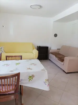a living room with a table and a couch at OASIS in Bovec
