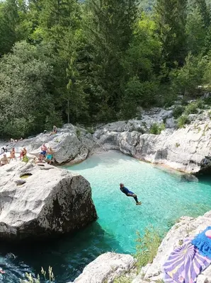 a person swimming in a pool of blue water at OASIS in Bovec