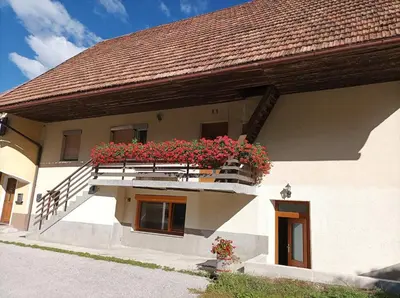 a building with a balcony with flowers on it at OASIS in Bovec