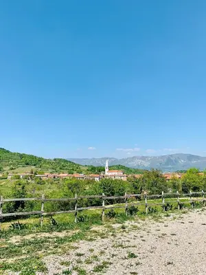 a fence on a hill with a town in the background at Samson and the Lilo in Vipava