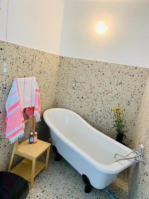 a bathroom with a bath tub in a room at Samson and the Lilo in Vipava