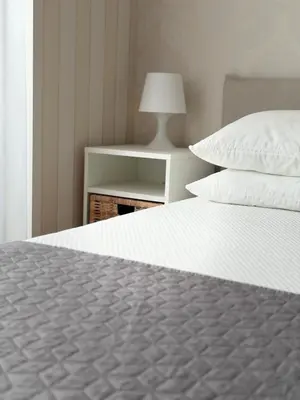 a white bed with two pillows on top of it at Villa Tatjana in Rogaška Slatina