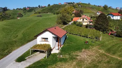 a small white house on a hill with a road at Holiday House Zlačka Gorca in Pristava pri Mestinju