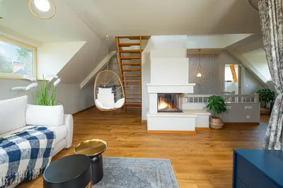 a living room with a couch and a fireplace at Villa Rory in Bled