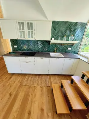 a kitchen with white cabinets and a sink at Villa Rory in Bled