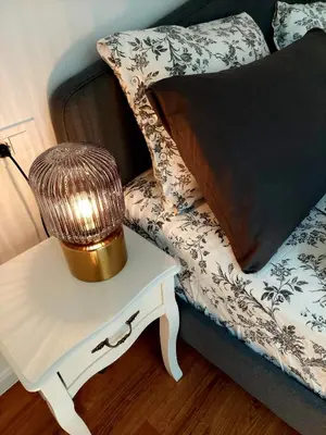 a lamp on a table next to a couch with a pillow at Villa Rory in Bled