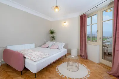 a bedroom with a bed and a large window at Villa Rory in Bled