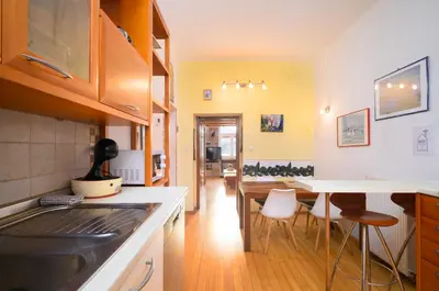 a kitchen and dining room with a table and chairs at Urban view apartment with free parking in Ljubljana