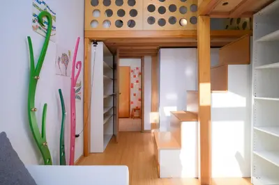 a small house with a staircase in a room at Urban view apartment with free parking in Ljubljana