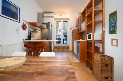 a kitchen with a table and a kitchen with a counter at Urban view apartment with free parking in Ljubljana