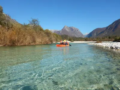 a group of people in a boat on a river at Počitniška HIŠKA POLOVNIK in Bovec