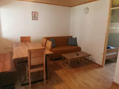 a living room with a couch and a table at Počitniška HIŠKA POLOVNIK in Bovec