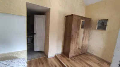 an empty room with a bed and a closet at Rock Apartments in Bohinjska Bela