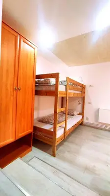 a room with two bunk beds and a cabinet at Rock Apartments in Bohinjska Bela