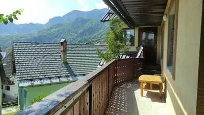 a balcony of a house with a view of a mountain at Rock Apartments in Bohinjska Bela