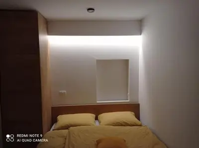 a bedroom with a bed with a light above it at Apartma Aurora in Kranjska Gora