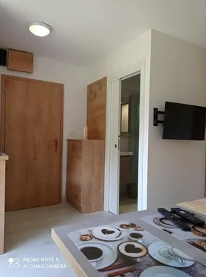 a kitchen with a table with plates on it at Apartma Aurora in Kranjska Gora