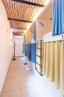 a corridor of a hospital with blue and yellow curtains at Boutique Hostel Angel in Ljubljana