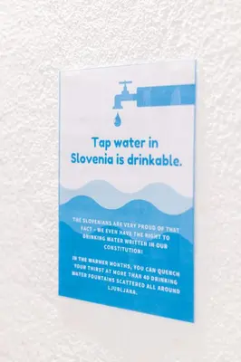 a sign on a wall that reads top water in snowmite is drinkable at Boutique Hostel Angel in Ljubljana