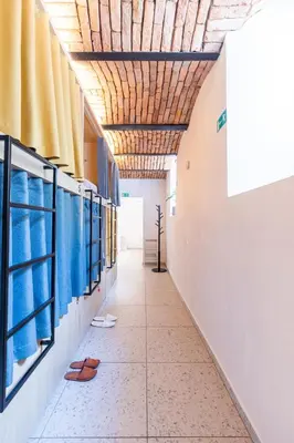 an empty corridor in a school building with shoes on the floor at Boutique Hostel Angel in Ljubljana