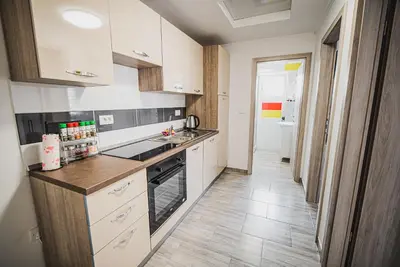 a kitchen with white cabinets and a stove top oven at CUDERLAND -CUKR in Kobarid
