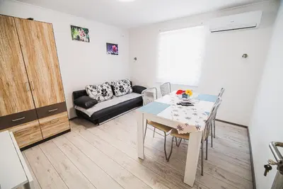 a living room with a table and a couch at CUDERLAND -CUKR in Kobarid