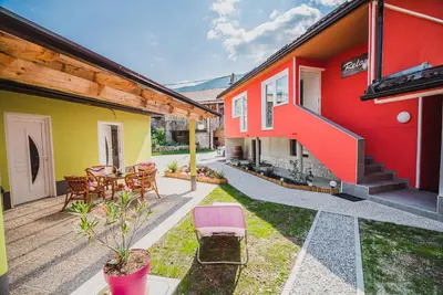 a house with a patio with a table and chairs at CUDERLAND -CUKR in Kobarid