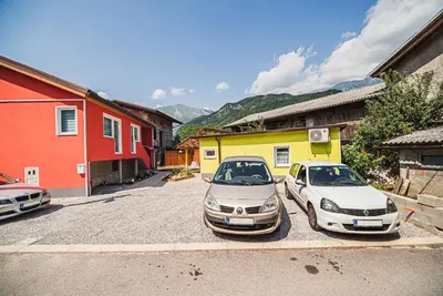 two cars parked in a parking lot in front of buildings at CUDERLAND -CUKR in Kobarid