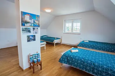 a small room with two beds and a table at Apartment Sneznik in Stari Trg pri Ložu