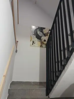a staircase with a painting on the wall next to a stair case at Apartma Maks & Anita in Bovec