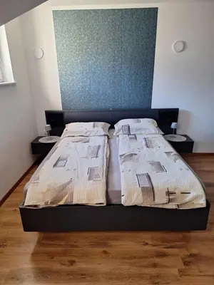 a bedroom with a bed with two night stands at Apartma Maks & Anita in Bovec