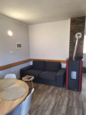 a living room with a couch and a fireplace at Apartma Maks & Anita in Bovec